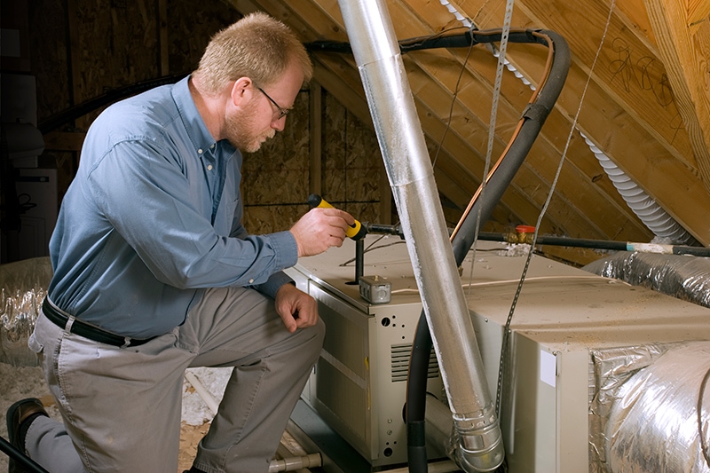 7 Furnace Maintenance Tips - Furnace Technician at Work.