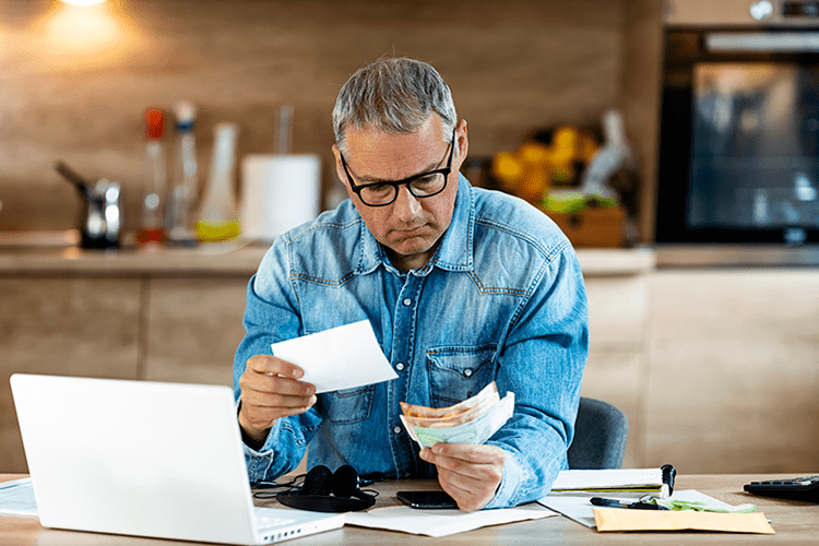 What Are the Benefits of Commercial HVAC Maintenance? Image is a photograph of a man sitting at a desk and reviewing flash cards.